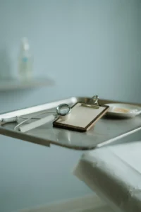 A calm clinical exam room with a scalp magnification tool resting on a tray