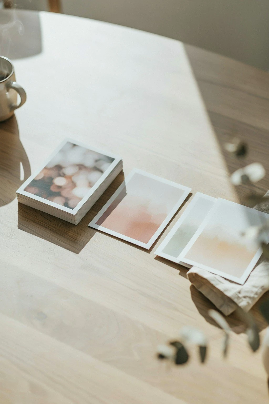 A small stack of printed monthly photos laid out in a simple timeline on a table