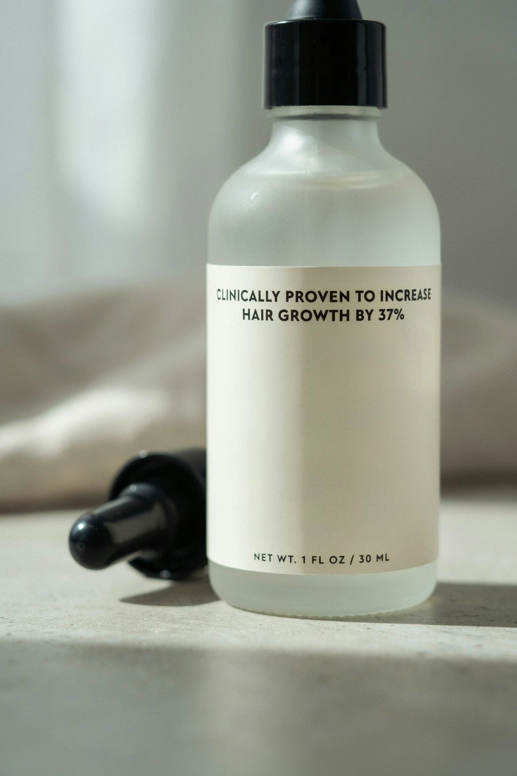 Close-up of a generic hair product label with a bold growth claim