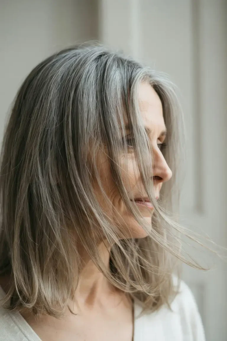 Woman with long layered hair showing movement through the mid-lengths and ends