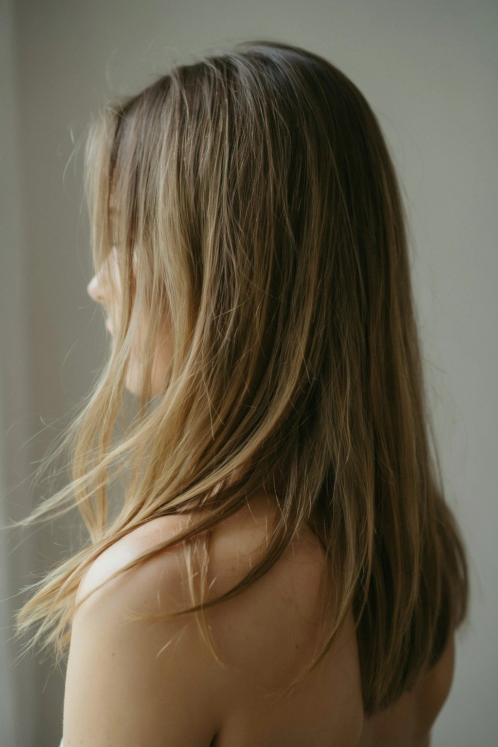 Woman with fine, long layered hair showing subtle movement at the ends