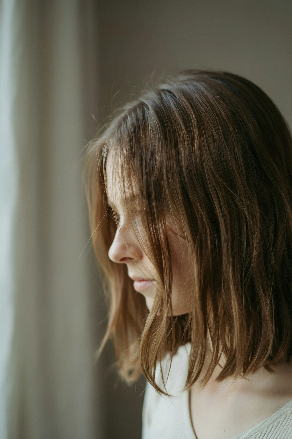 Woman with a longer, layered lob-length haircut