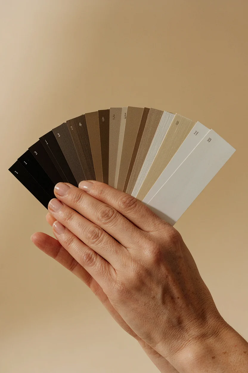 Close-up of a professional color swatch ring held in a woman's hand